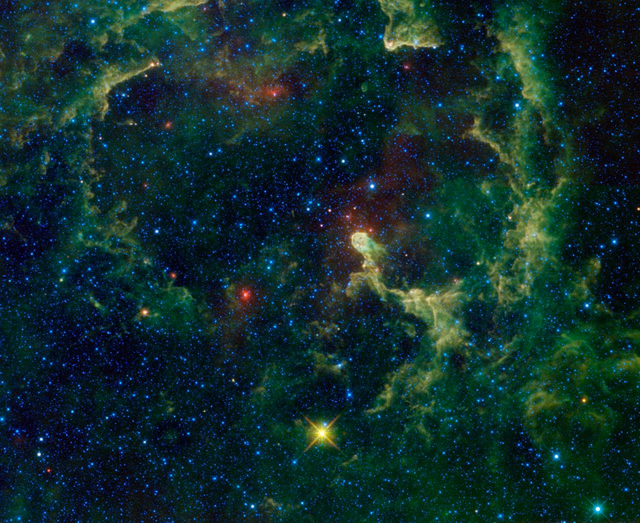 The Elephant's Trunk Nebula IC 1396 — a dark dust pillar embedded in glowing hydrogen, with embedded young stars.